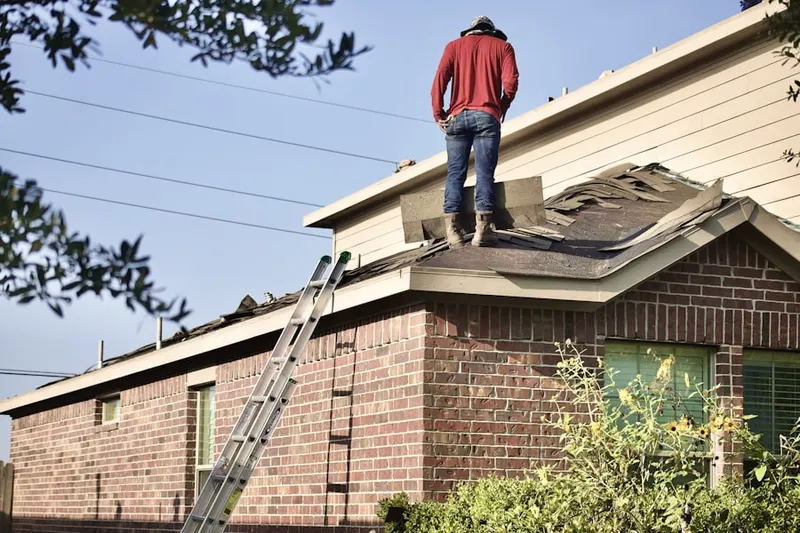 Professional roofer working on a residential roof in Clarke Farms